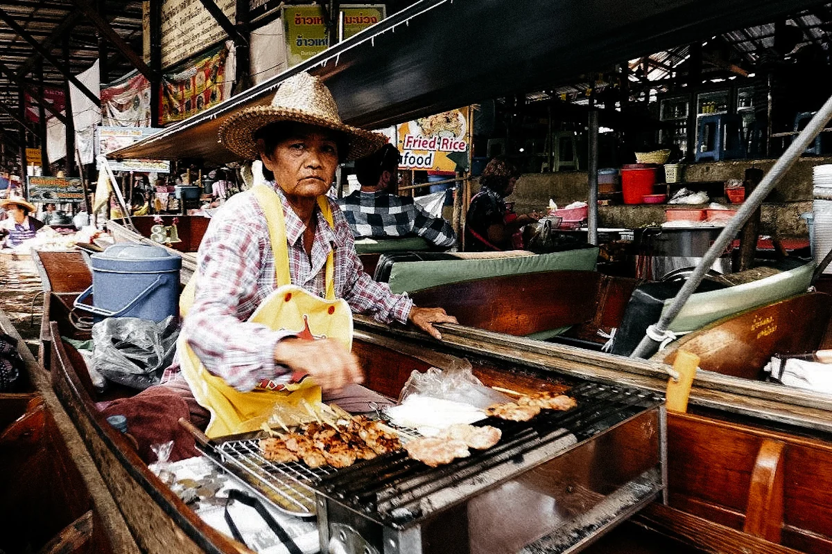 Señora en barca en el mercado flotante de Damnoen Saduak, Tailandia